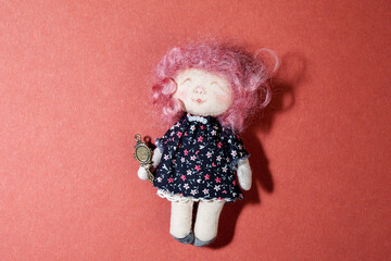 Girl rag doll isolated on red background