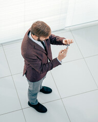 top view. business man looking at the screen of his smartphone.