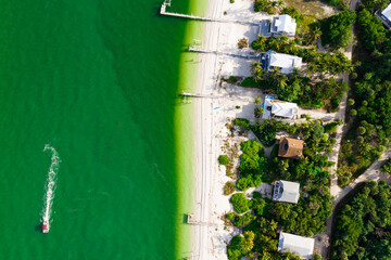 summer vacation getaway with green water from above with drone