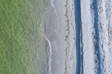 epic drone shot of waves breaking on empty tropical beach