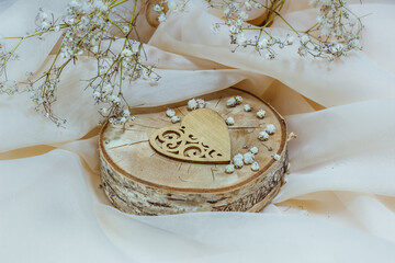 valentine's day background with wooden beautiful heart and white flowers on light background