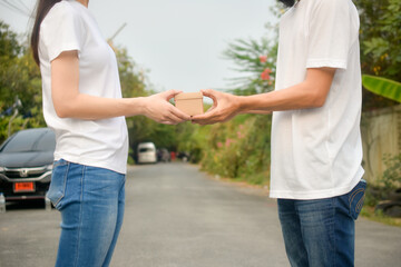 Obraz premium People giving giftbox concept happy new year, Valentine's day, Man giving giftbox to women