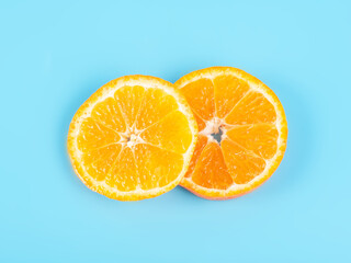 Orange tangerine slice on blue background