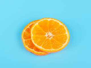 Orange tangerine slice on blue background