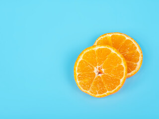 Orange tangerine slice on blue background