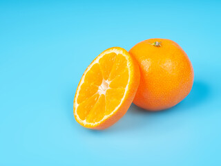 Orange tangerine slice on blue background