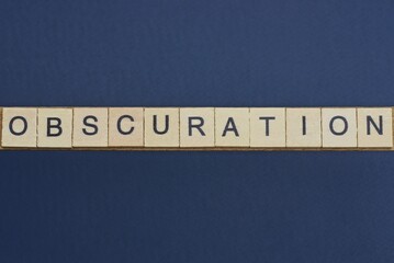  text  word obscuration from gray wooden letters on a black table
