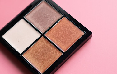 Set of decorative cosmetics on color background. Eyeshadow in brown color