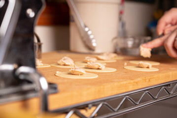 Making Pasta and Tortellini at Home on Wooden Rack and Chrome Pasta Maker