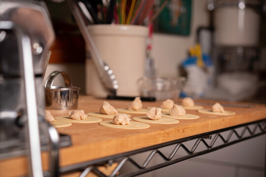 Making Pasta and Tortellini at Home on Wooden Rack and Chrome Pasta Maker