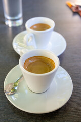Drinking of strong black espresso coffee on outdoor terrace in cafe
