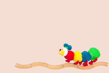 a caterpillar-shaped toy that crawls along a railroad track.