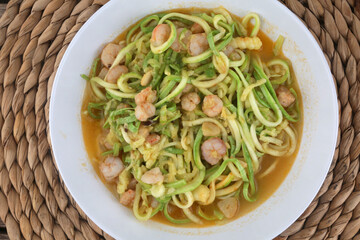 fresh and raw zucchini spaguetti with prawns as imitation of italian pasta for vegetarian food