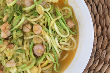 fresh and raw zucchini spaguetti with prawns as imitation of italian pasta for vegetarian food