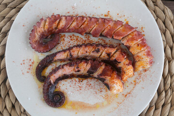 fresh octopus with potatoes in red paprika as diet food