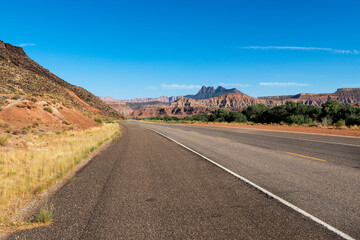 Fototapeta na wymiar Scenic road near the Zion National Park in the State of Utah, with the beautiful red sandstone mountains.