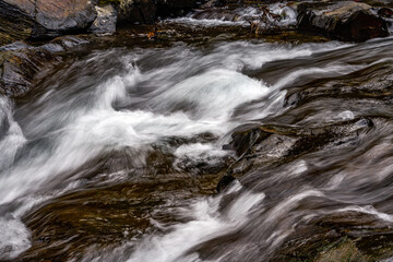 Close-up of the slow water flow of a mountain stream