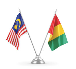 Guinea and Malaysia table flags isolated on white 3D rendering