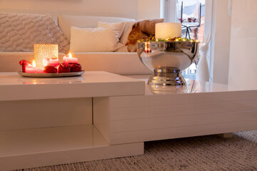 Decorative ambience with candle in the champagne cooler on table.