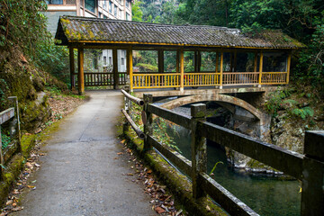 Fototapeta premium Guilin Longsheng's mountain stream architecture, small stream tile-top bridge