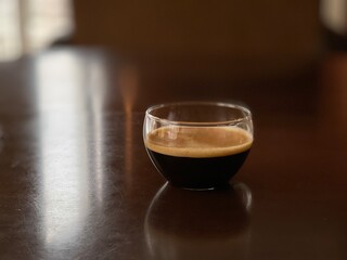 glass cup with black coffee on the table
