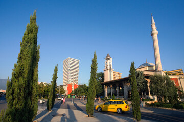 view of Alnabia life style with The Et'hem Bey Mosque and clock tower , located in the city center of the Albanian capital Tirana illuminated by the sun. Tirana, Albania.