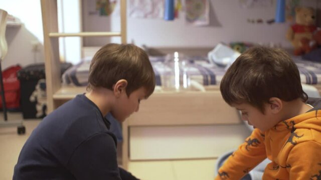Footage of two caucasian kids , playing together at their bedroom , during coronavirus quarantine 4K, close up tight
