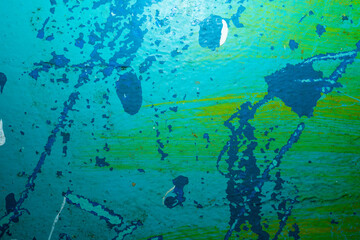 Wall with peeling paint, old multi-colored paint in several layers on the wall.