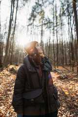happy young woman in autumn winter forest