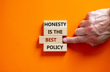 Honesty is the best policy symbol. Wooden blocks. Text 'honesty is the best policy', businessman hand. Beautiful orange background, copy space. Business and honesty is the best policy concept. - obrazy, fototapety, plakaty