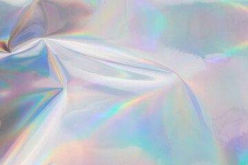 Rainbow halographic wrinkled foil background. Abstract pastel color background.