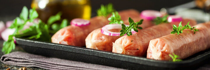 Kupaty - raw shashlik sausage of pork barbecue. Raw sausage for grill.  Picnic. Selective focus. Banner