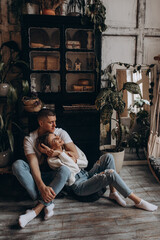 The guy hugs his girlfriend. A loving couple in a cozy home environment. Studio photography.