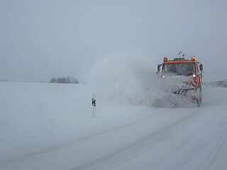 winter service vehicle removing snow from a street in germany