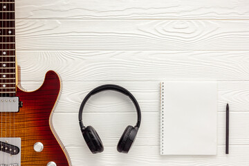 Desk of musician for songwriter work set with headphones and guitar