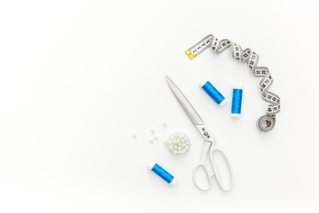 Sewing accessories and sewing supplies. Spools of thread, scissors and centimeter