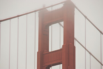top of a tower of Golden Gate bridge in fog	
