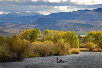 Anglers floating a Montana river and fishing in the fall in Montana and fly fishing from a drift...