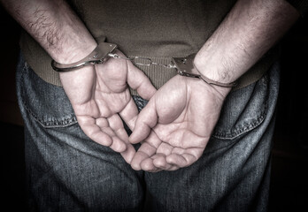 man hands in handcuffs