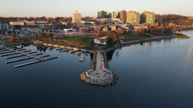 City of Barrie waterfront and downtown aerial drone dolly shot with Lake Simcoe marina, condo buildings, banks, parks and infrastructure. Clear fall day.
