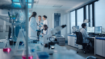 Medical Science Laboratory with Diverse Multi-Ethnic Team of Microbiology Scientists Have Meeting...