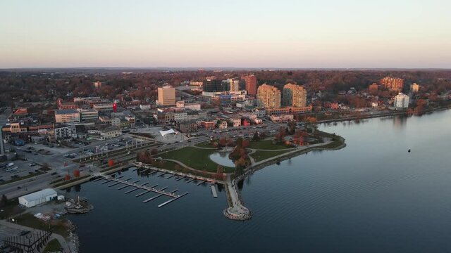 City of Barrie waterfront and downtown aerial drone dolly shot with Lake Simcoe marina, condo buildings, banks, parks and infrastructure. Clear fall day.