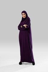 Purple. Beautiful arab woman posing in stylish hijab isolated on studio background with copyspace for ad. Fashion, beauty, style concept. Female model with trendy make up, manicure and accessories.