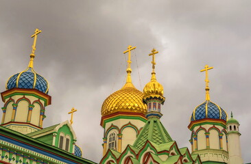Fototapeta na wymiar Bright multicolored carved domes of an Orthodox church