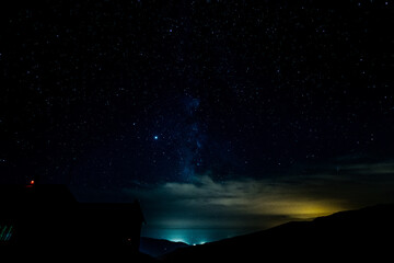Fototapeta premium Starry sky surrounded by mountains