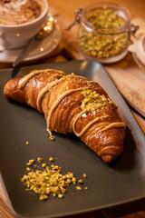 breakfast with creamy brioche, pistachio nuts and cappuccino