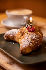 breakfast with chocolate raspberry and currant croissant and italian cappuccino