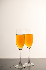 ..Two glasses of champagne on the black table. Alcoholic drink: champagne, beer, white wine. New year and Christmas background. Valentine's Day. Vertical photo