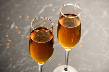 Two glasses of champagne on the black background. Alcoholic drink: champagne, beer, white wine. New year and Christmas background. Valentine's Day.