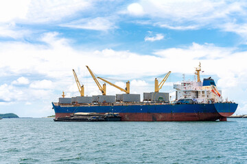 Large cargo ship for logistic import export goods and other anchor at sea in bright day
